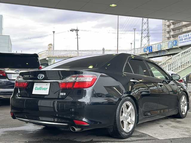 トヨタ カムリ ハイブリット Gパッケージ 京都府 2016(平28)年 10.5万km アティチュードブラックマイカ 純正ＳＤナビ　/（NSZN-W64T、7インチ）/フルセグＴＶ　/禁煙車　/バックカメラ　/Bluetooth/CD/DVD再生機能有/USB/クルーズコントロール/パワーステアリング/パワーウィンドウ　/Ｄ席パワーシート　/後席ベンチシート/スマートキー　/純正ＡＷ１７インチ/前後社外ドライブレコーダー/（CA-XDR50D)　/ウィンカーミラー/フロントフォグランプ/キセノンヘッドライト　/オートライト/電動格納ミラー　/アイドリングストップ　/デュアルエアコン/横滑り防止装置/盗難防止装置/Wサイドエアバッグ/カーテンエアバッグ/衝突被害軽減ブレーキ