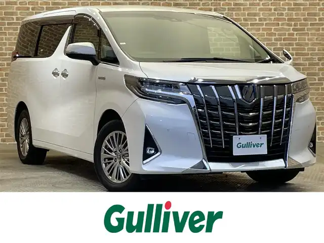 トヨタ アルファードハイブリット 岩手県 2019(令1)年 4.6万km ホワイトパールクリスタルシャイン ４WD/MTモード付AT/両側パワースライドドア/パワーバックドア/100V電源/パワーシート/プリクラッシュセーフティ/レーンアシスト/コーナーセンサー/パーキングサポートブレーキ/ロードサインアシスト/先行車発進告知機能/クルーズコントロール/アイドリングストップ/横滑り防止装置/オートライト/オートハイビーム/オットマン/オールオートパワーウィンドウ/純正ナビ/純正フロアマット/ドライブレコーダー/ETC2.0