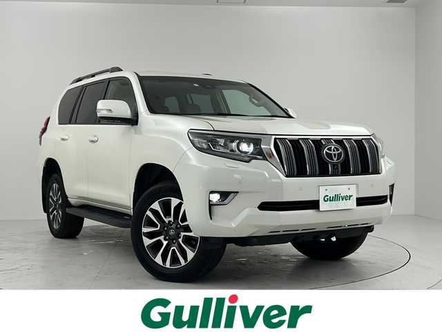 トヨタ ランドクルーザー プラド TX Lパッケージ 大阪府 2023(令5)年 4.9万km ホワイトパールクリスタルシャイン 純正ナビ　(ディスプレイオーディオ)/全方位カメラ　/サンルーフ　/クルーズコントロール　/衝突軽減システム　/レーンキープアシスト　/横滑り防止装置　/エアシート　/シートヒーター　/７人乗り　/オプション１９インチアルミホイール　/ＬＥＤヘッドライト/オートライト/オートハイビーム/フォグランプ/ヘッドライトウォッシャー/革巻きステアリング/ステアリングスイッチ/ルーフレール/プッシュスタート/スマートキー/スペアキー