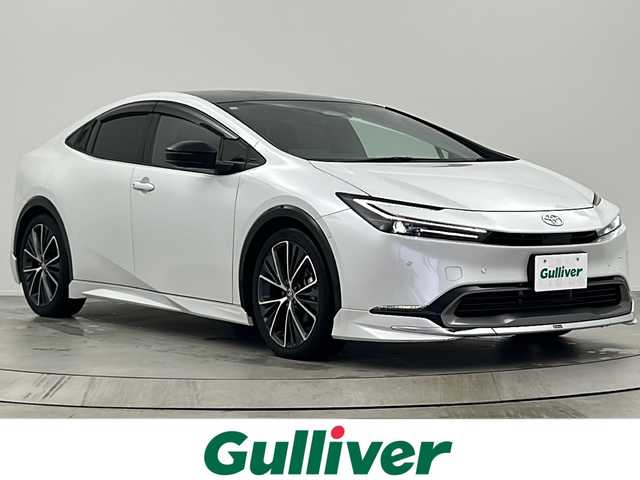 トヨタ プリウス Z 大阪府 2023(令5)年 2.3万km プラチナホワイトパールマイカ モデリスタフルエアロ/パノラマルーフ/12.3型DAナビ/【フルセグTV/FM/BT/USB/AppleCarPlay/AndroidAuto】/デジタルインナーミラー/ワイヤレス充電/100V電源/全方位カメラ/ビルトインＥＴＣ2.0/BSM/トヨタセーフティセンス/・プリクラッシュセーフティ/・緊急時操舵支援/・レーントレーシングアシスト＋レーンディパーチャーアラート/・レーダークルーズコントロール/・オートマチックハイビーム/・ロードサインアシスト/・ドライバー異常時対応システム /・プロアクティブドライビングアシスト/・発進遅れ告知機能/メモリシート/パワーシート/シートヒーター/シートクーラー/ステアリングヒーター/レザーシート/純正AW/パワーバックドア