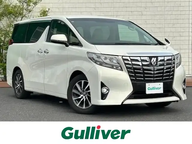 トヨタ アルファード G 茨城県 2015(平27)年 5.9万km ラグジュアリーホワイトパールクリスタルシャインガラスフレーク 社外ナビ /（BT/AM/FM/フルセグTV）/４ＷＤ　/クルーズコントロール追尾あり/ＥＴＣ　/両側パワースライドドア　/メモリー付きパワーシート　/コーナーセンサー前後　/ＬＥＤライト　/オットマン　/アイドリングストップ　/スマートキー/純正ＡＷ　