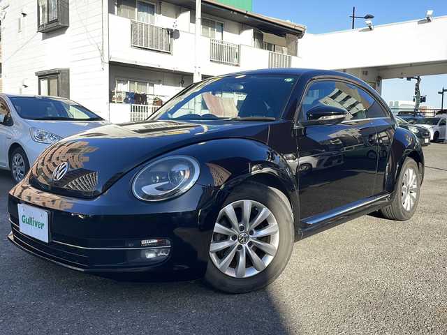 フォルクスワーゲン ザ・ビートル デザイン 宮崎県 2013(平25)年 8.6万km ディープブラックパールエフェクト ・クルーズコントロール　/・Bluetooth/・スペアキー/・スマートキー/・ETC/・電動格納ミラー/・純正SDナビ/・フルセグTV/・MTモード付AT/・純正HDDナビ/・純正フロアマット/・純正アルミホイール/・横滑り防止装置/・ミュージックプレイヤー　AUX/・シガーソケット