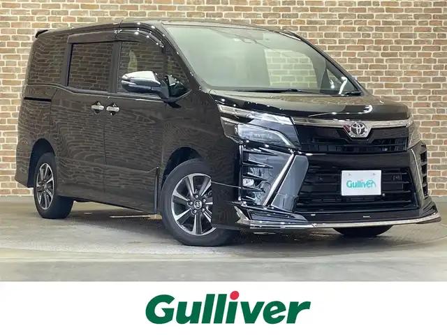 トヨタ ヴォクシー ZS 煌Ⅲ 岩手県 2021(令3)年 0.9万km ブラック ４WD/モデリスタフロントスポイラー/寒冷地仕様/両側パワースライドドア/トヨタセーフティセンスC/プリクラッシュセーフティ/レーンディパーチャーアラート/オートマチックハイビーム/先行車発進告知機能/クルーズコントロール/横滑り防止装置/アイドリングストップ/MTモード付きAT/クリアランスソナー/純正10.5インチナビ/バックカメラ/ETC/ドライブレコーダー/ロールサンシェード/リヤオートエアコン/LEDヘッドランプ/純正16インチアルミホイール