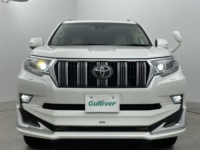 トヨタ ランドクルーザー プラド TX Lパッケージ 岡山県 2022(令4)年 2.7万km ホワイトパールクリスタルシャイン モデリスタエアロ/サンルーフ/純正9インチナビ/・FM/AM/Bluetooth/フルセグ/CD/DVD/バックカメラ/ベージュレザーシート/・パワーシート/・シートヒーター/・ベンチレーション/トヨタセーフティーセンス/・プリクラッシュセーフティ/・レーンディパーチャーアラート/・オートマチックハイビーム/・レーダークルーズコントロール/ビルトインETC/ドライブレコーダー/電動格納サードシート/ブラックルーフレール/LEDヘッドライト/MTモード付シフト/HDMI/USB接続