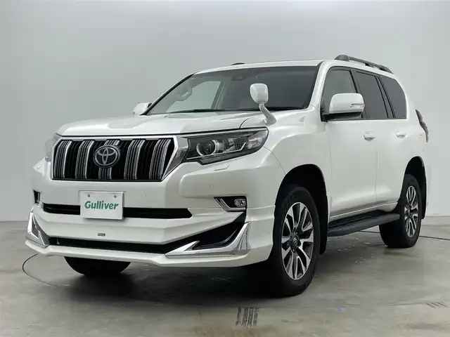 トヨタ ランドクルーザー プラド TX Lパッケージ 岡山県 2022(令4)年 2.7万km ホワイトパールクリスタルシャイン モデリスタエアロ/サンルーフ/純正9インチナビ/・FM/AM/Bluetooth/フルセグ/CD/DVD/バックカメラ/ベージュレザーシート/・パワーシート/・シートヒーター/・ベンチレーション/トヨタセーフティーセンス/・プリクラッシュセーフティ/・レーンディパーチャーアラート/・オートマチックハイビーム/・レーダークルーズコントロール/ビルトインETC/ドライブレコーダー/電動格納サードシート/ブラックルーフレール/LEDヘッドライト/MTモード付シフト/HDMI/USB接続