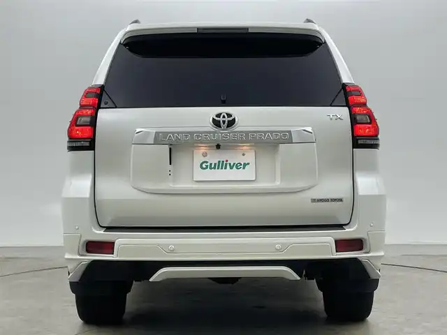 トヨタ ランドクルーザー プラド TX Lパッケージ 岡山県 2022(令4)年 2.7万km ホワイトパールクリスタルシャイン モデリスタエアロ/サンルーフ/純正9インチナビ/・FM/AM/Bluetooth/フルセグ/CD/DVD/バックカメラ/ベージュレザーシート/・パワーシート/・シートヒーター/・ベンチレーション/トヨタセーフティーセンス/・プリクラッシュセーフティ/・レーンディパーチャーアラート/・オートマチックハイビーム/・レーダークルーズコントロール/ビルトインETC/ドライブレコーダー/電動格納サードシート/ブラックルーフレール/LEDヘッドライト/MTモード付シフト/HDMI/USB接続
