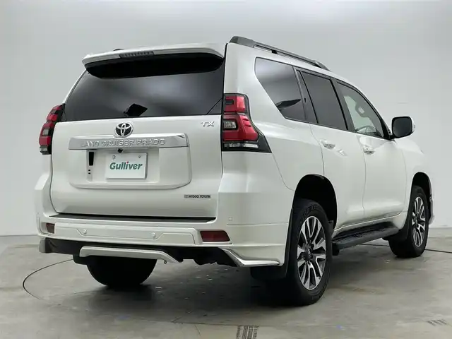 トヨタ ランドクルーザー プラド TX Lパッケージ 岡山県 2022(令4)年 2.7万km ホワイトパールクリスタルシャイン モデリスタエアロ/サンルーフ/純正9インチナビ/・FM/AM/Bluetooth/フルセグ/CD/DVD/バックカメラ/ベージュレザーシート/・パワーシート/・シートヒーター/・ベンチレーション/トヨタセーフティーセンス/・プリクラッシュセーフティ/・レーンディパーチャーアラート/・オートマチックハイビーム/・レーダークルーズコントロール/ビルトインETC/ドライブレコーダー/電動格納サードシート/ブラックルーフレール/LEDヘッドライト/MTモード付シフト/HDMI/USB接続
