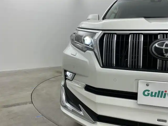 トヨタ ランドクルーザー プラド TX Lパッケージ 岡山県 2022(令4)年 2.7万km ホワイトパールクリスタルシャイン モデリスタエアロ/サンルーフ/純正9インチナビ/・FM/AM/Bluetooth/フルセグ/CD/DVD/バックカメラ/ベージュレザーシート/・パワーシート/・シートヒーター/・ベンチレーション/トヨタセーフティーセンス/・プリクラッシュセーフティ/・レーンディパーチャーアラート/・オートマチックハイビーム/・レーダークルーズコントロール/ビルトインETC/ドライブレコーダー/電動格納サードシート/ブラックルーフレール/LEDヘッドライト/MTモード付シフト/HDMI/USB接続