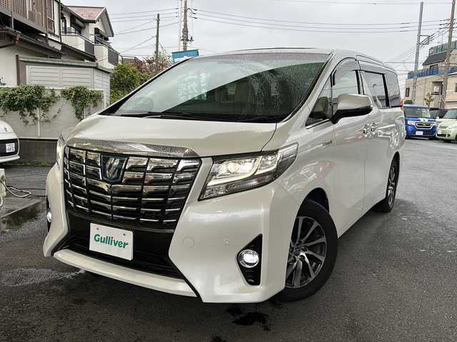 トヨタ アルファードハイブリット エグゼクティブ ラウンジ 埼玉県 2015(平27)年 11.9万km ホワイトパールクリスタルシャイン 運転席エアバッグ	/助手席エアバッグ	/サイドエアバッグ	/ABS(アンチロックブレーキ)	/トラクションコントロール	/前席シートベルトプリテンショナー	/前席シートベルトフォースリミッター	/後席３点式シートベルト	/サイドインパクトバー	/ブレーキアシスト	/衝突安全ボディー	採用/EBD（電子制動力配分装置）	/盗難防止システム	/その他安全装備	VSC/ナビゲーション	/ナビゲーションメディア	メモリータイプ/サウンド（カセット&MD）	AM/FMラジオ/CDプレイヤー/エアコン	デュアルエアコン/パワーウィンドウ	/集中ドアロック		/クルーズコントロール	/革シート/運転席パワーシート	/ウッドパネル	/サンルーフ/アルミホイール	17インチ標準/UVカットガラス	/プライバシーガラス/ETC/パワーバックドア/オットマン/両側パワースライドドア/クルーズコントロール/フルセグテレビ/プッシュスタート/バックカメラ/フリップダウンモニター