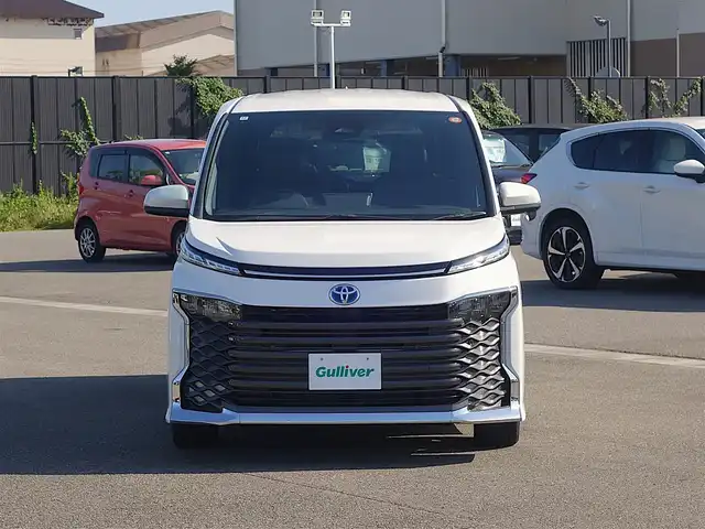 トヨタ ヴォクシー ハイブリッド S－Z 山形県 2024(令6)年 0.5万km ホワイトパールクリスタルシャイン トヨタセーフティセンス/純正フリップダウンモニター (V13T-R72R)/純正ディスプレイオーディオ/　　【BT USB AM/FM Miracast】/バックカメラ/両側パワースライドドア/レーダークルーズコントロール/LEDオートヘッドライト/ハーフレザーシート/シートヒーター/純正17インチアルミホイール/コーナーセンサー/アイドリングストップ/ステアリングスイッチ/電動格納ウィンカーミラー/BSM/フロアマット/スマートキー/ETC2.0