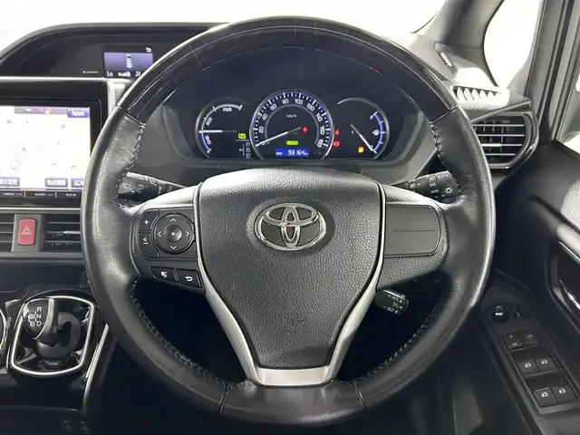 トヨタ エスクァイア ハイブリッド Gi 佐賀県 2015(平27)年 9.4万km スパークリングブラックパールクリスタルシャイン 純正９インチナビ【NSZT-Y64T】/（フルセグTV/CD/DVD/SD/BT/AM・FM）/純正１１インチ後席モニター/モデリスタエアロ（フロント・サイド・リアアンダー）/バックカメラ/衝突被害軽減システム/前後ドライブレコーダー/ハーフレザーシート/両側パワースライドドア/クルーズコントロール/ビルトインＥＴＣ/純正アルミホイール/純正フロアマット/純正LEDヘッドライト/オートライト/スペアキー×１