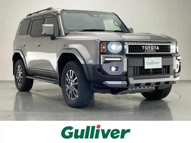トヨタ ランドクルーザー ２５０ VX 愛知県 2024(令6)年 2.9万km アバンギャルドブロンズメタリック 純正１２．３インチディスプレイオーディオ/トヨタチームメイト　/丸目ヘッドライト　/モデリスタＰＫＧ　/シグネチャーイルミブレード　/モデリスタオーバーフェンダー　/リアバンパーステップガード/トヨタセーフティセンス/デジタルインナーミラー/アラウンドビューモニター/ムーンルーフ/ブラインドスポットモニター/HDMI/ステアリングヒーター/レーダークルーズコントロール/黒革シート/パワーシート/パワーバックドア/シートヒーター/エアシート/フルセグTV/前後ドライブレコーダー/ETC2.0/純正アルミホイール/純正フロアマット/LEDオートライト/フォグランプ/Miracast/衝突被害軽減ブレーキ
