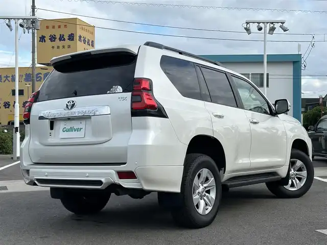 トヨタ ランドクルーザー プラド TX Lパッケージ 愛媛県 2023(令5)年 2.1万km ホワイトパールクリスタルシャイン 登録時走行距離：20800km/メーカーオプション純正メモリナビ/AM/FM/フルセグTV/Bluetooth/ETC/電動サードシート/パドルシフト/追従クルコン/レザーシート/シートヒーター/エアシート/衝突軽減システム/横滑り防止装置/盗難防止装置/レーンキープアシスト/LEDヘッドライト/オートライト/オートハイビーム/エンジンスタートボタン/スマートキー/スペアキー/純正アルミホイール/社外フロアマット