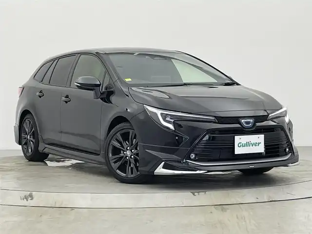 トヨタ カローラツーリング ハイブリッド ダブルバイビー 宮城県 2022(令4)年 0.8万km アティチュードブラックマイカ 4WD/ワンオーナー/純正10.5インチディスプレイオーディオ/(AM/FM/USB/BT/TV/Miracast)/バックカメラ/ETC2.0/トヨタセーフティーセンス/レーダークルーズコントロール/BSM/置くだけ充電/TVキャンセラー/ハーフレザー/シートヒーター/ステアリングヒーター/SOSスイッチ/プッシュスタート/スマートキー/スペアキー/オートライト/オートマチックハイビーム/LEDヘッドライト/フォグランプ/ヘッドライトレベライザー/モデリスタエアロ/純正フロアマット/純正17インチアルミホイール