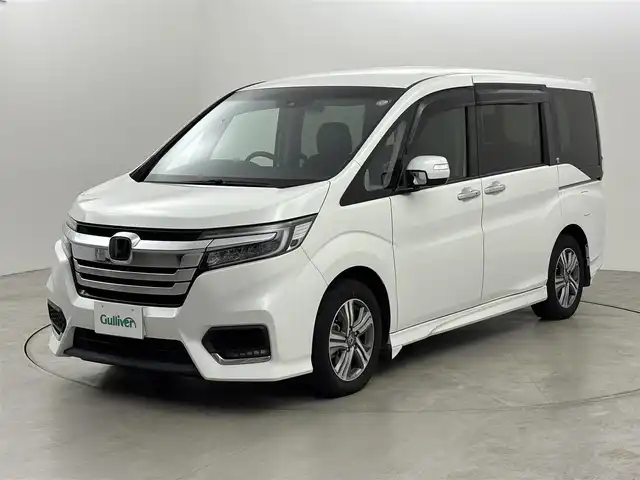 ホンダ ステップワゴン スパーダ eHEV G EXホンダS 福岡県 2021(令3)年 3.7万km プラチナホワイトパール 後席モニター　/社外10型ナビ/わくわくゲート　/ビルトインＥＴＣ２．０　/レーダークルーズコントロール　/ホンダセンシング　/衝突被害軽減ブレーキ　/レーンキープ　/先行車発進お知らせ　/標識認識機能　/両側電動スライドドア　/ハーフレザーシート　/シートヒーター　/純正16インチアルミホイール