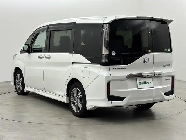 ホンダ ステップワゴン スパーダ eHEV G EXホンダS 福岡県 2021(令3)年 3.7万km プラチナホワイトパール 後席モニター　/社外10型ナビ/わくわくゲート　/ビルトインＥＴＣ２．０　/レーダークルーズコントロール　/ホンダセンシング　/衝突被害軽減ブレーキ　/レーンキープ　/先行車発進お知らせ　/標識認識機能　/両側電動スライドドア　/ハーフレザーシート　/シートヒーター　/純正16インチアルミホイール