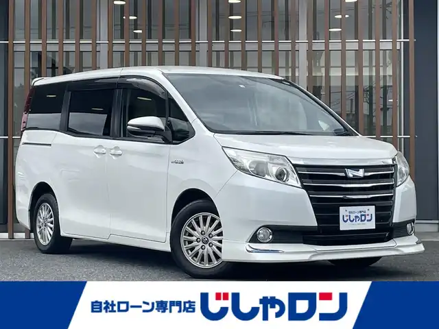 トヨタ ノア ハイブリッド G 鳥取県 2014(平26)年 13.7万km ホワイトパールクリスタルシャイン (株)IDOMが運営する【じしゃロン鳥取店】の自社ローン専用車両になります。こちらは現金またはオートローンご利用時の価格です。自社ローンご希望の方は別途その旨お申付け下さい/純正9インチSDナビ/（AM/FM/DTV/BT/CD/DVD）/フリップダウンモニター/クルーズコントロール/シートヒーター/両側パワースライドドア/エアロ（フロント）/LEDヘッドライト/プッシュスタート/ETC/スマートキー/スペアキー