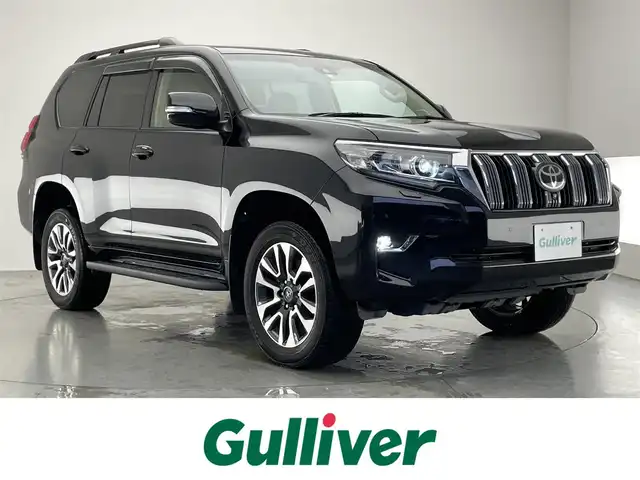 トヨタ ランドクルーザー プラド TX Lパッケージ 愛知県 2022(令4)年 1.8万km アティチュードブラックマイカ メーカー9型ＤＡナビ/ETC2.0/全方位カメラ/ベージュ内装/本革シート/パワーシート/7人乗り/サンルーフ/ルーフレール/19インチアルミホイール/スペアタイヤ/BSM/レーダークルーズコントロール/禁煙車