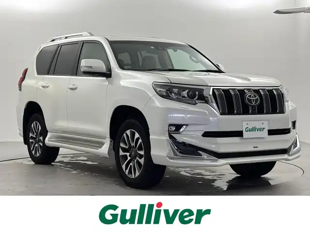 トヨタ ランドクルーザー プラド TX Lパッケージ 福井県 2023(令5)年 1.8万km ホワイトパールクリスタルシャイン 純正ディスプレイオーディオ/アラウンドビューモニター/スペアキー/サンルーフ/モデリスタエアロ（フロント＆リア）/純正１９インチＯＰアルミホイール/寒冷地仕様/ニュートラルベージュシート/シートヒーター＆ベンチレーション/ルーフレール/ドラレコ前後（SD欠）/保証書＆取説/純正ビルトインETC