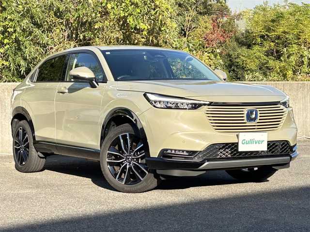 ホンダ ヴェゼル ハイブリッド e:HEV Z 長崎県 2024(令6)年 3.5万km ベージュ プッシュスタート/純正ナビ付ディスプレイオーディオ（AM/FM/USB/TV)/電子パーキングブレーキ/ビルトインETC2.0/USB×２/ブレーキホールド/ドライブレコーダー（前後）/パドルシフト/シートヒーター（前席）/ハンドルヒーター/ブラインドスポットモニター/クルーズコントロール（追従あり）/レーンキープアシスト/ブルートゥース/コーナーセンサー（前後）/カーテンエアバッグ/パワーバックドア/LEDライト/フォグランプ
