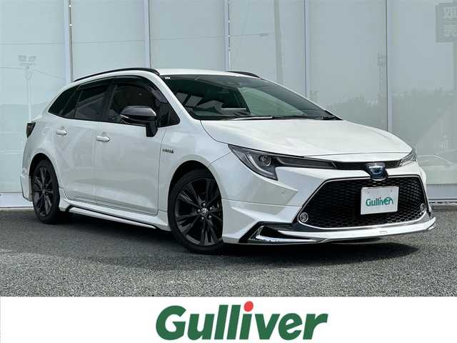 トヨタ カローラツーリング ハイブリッド ダブルバイビー 福岡県 2020(令2)年 4.7万km ホワイトパールクリスタルシャイン ・MODELISTAフルエアロ/・純正ナビ（TV/Bluetooth/Miracast）/・バックカメラ/・ドライブレコーダー（PORMIDO/前後）/・ETC2.0/・トヨタクリアランスソナー/・クルーズコントロール（追従可能）/・レーンキープアシスト/・横滑り防止装置/・衝突被害軽減システム/・D/N席シートヒーター/・オートマチックハイビーム/・LEDヘッドライト/・フットランプ/・ワイヤレス充電/・電動パーキングブレーキ/・ヒートステアリング/・ステアリングスイッチ/・電格ミラー/・トノカバー
