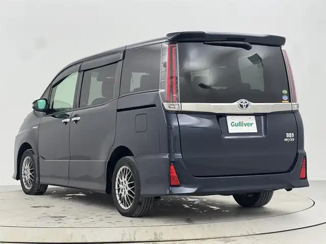 トヨタ ノア ハイブリッド Si ダブルバイビーⅡ 熊本県 2019(令1)年 3.3万km ブラッキッシュアゲハガラスフレーク 社外９インチナビ/   フルセグTV/CD/DVD/Bluetooth/USB/バックモニター/１０．１インチ後席モニター/（登録時走行距離 32629km）/衝突軽減ブレーキ/横滑り防止装置/前席シートヒーター/クルーズコントロール/両側パワースライドドア/ドライブレコーダー/ハーフレザーシート/オートマチックハイビーム/純正16インチアルミホイール/コーナーセンサー/プッシュスタート/スマートキー/ＥＴＣ/ＬＥＤライト