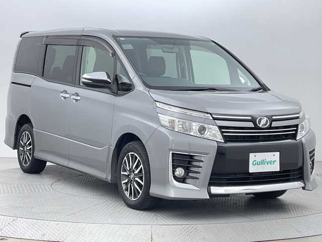 トヨタ ヴォクシー ZS 煌 新潟県 2015(平27)年 6.5万km アイスチタニウムマイカメタリック 禁煙車/4WD/社外メモリナビ/フルセグ/　CD/DVD/Bluetooth/社外フリップダウンモニター/バックカメラ/両側パワースライドドア/スマートキー/純正エンジンスターター/LEDヘッドライト/オートライト/フォグランプ/革巻きステアリング/ワイパーデアイサー/プッシュスタート/ETC/社外アルミ付きスタッドレス/　（積み込み６mm）