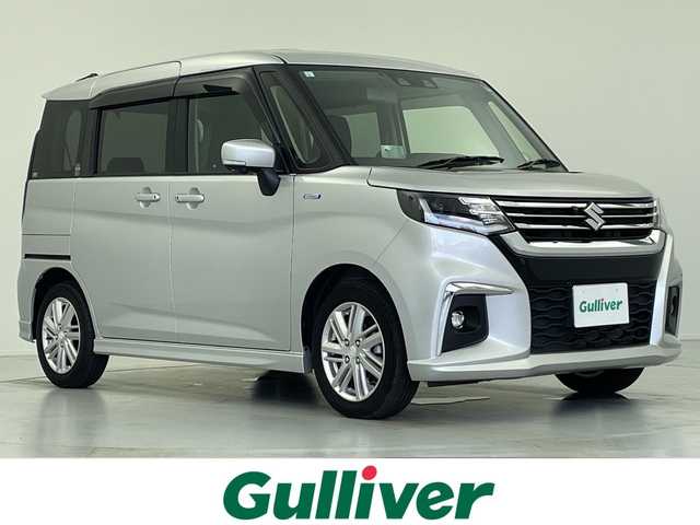 スズキ ソリオ HV MZ 愛知県 2021(令3)年 0.7万km スターシルバーメタリック 両側パワースライドドア/純正メモリナビ(フルセグTV/CD/DVD/AM・FM/BT/USB/AppleCarPlay/AndroidAuto)/アラウンドビューモニター/ETC/前席シートヒーター/ヘッドアップディスプレイ(HUD)/クリアランスソナー/クルーズコントロール/レーンアシスト/LEDヘッドライト/純正15インチアルミホイール/純正フロアマット/スペアキー/取扱説明書/保証書