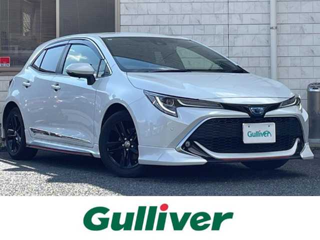 トヨタ カローラ スポーツ ハイブリッドG スタイルPKG 福岡県 2020(令2)年 3.4万km プラチナホワイトパールマイカ TRDエアロ【フロント・リア・サイド】/TRDドアハンドルプロテクター/TRDペダルカバー【ブレーキ・アクセル】/サイドドアアンダーガーニッシュ/ステアリングガーニッシュ/専用ドリンクホルダー(D席)/黒ハーフレザーシート/純正9インチディスプレイオーディオ/(USB/AM/FM/Bluetooth/CD/DVD/フルセグTV】/CD・DVDデッキ/バックカメラ/ビルトインETC/前後ドライブレコーダーCOMTEC【DC-DR652】/Toyota Safety Sense/・PCS(プリクラッシュセーフティ)/・LTA(レーントレーシングアシスト)/・RSA(ロードサインアシスト)/・オートマチックハイビーム/・先行車発進告知機能/・レーダークルーズコントロール(全車速追従機能付き)/BSM(ブラインドスポットモニター)/RCTA(リヤクロストラフィックアラート)/PKSB(パーキングサポートブレーキ)/オートライト/クリアランスソナー/コーナーセンサー/シートヒーター(D/N席)/ブレーキホールド/電格ウィンカーミラー/純正フロアマット/純正16インチアルミホイール/USB充電ソケット/スペアキー×１/ドアバイザー/取扱説明書/保証書