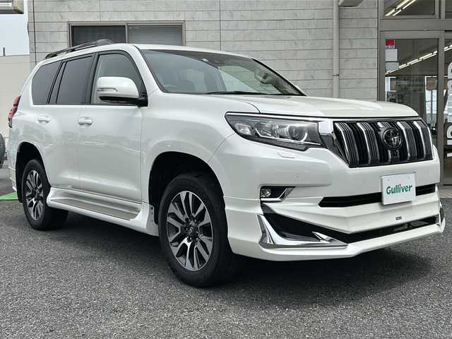 トヨタ ランドクルーザー プラド TX Lパッケージ 埼玉県 2022(令4)年 2.1万km ホワイトパールクリスタルシャイン 純正ナビ（TV／BT／AM／FM）/ETC2.0/スペアタイヤ/前席シートヒーター/前席パワーシート/デジタルインナーミラー　/レーンアシスト　/クルーズコントロール　/コーナーセンサー　/電格ミラー　/衝突軽減　/ISOFIX/フルエアロ（モデリスタ）/社外マフラー（モデリスタ）/バックカメラ/プッシュスタート/ライトウォッシャー/ライトレベライザー/ルーフレール/3列シート