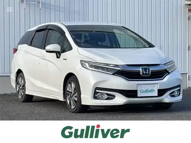 ホンダ シャトル ハイブリッド X ホンダセンシング 熊本県 2018(平30)年 11.2万km ホワイトオーキッドパール 純正ナビ（Gathers　VXM-187VFEi)/フルセグTV/BT/CD/DVD/USB/HDMI/ipod)/バックカメラ/純正フロアマット/ホンダセンシング/・路外逸脱抑制機能/・衝突軽減ブレーキ/・先行車発進お知らせ機能/・横滑り防止/・アダプティブクルーズコントロール/・車両接近お知らせ/・標識認識機能/・誤発進抑制機能/・歩行者事故低減ステアリング/・車線維持支援システム/・オートハイビーム/ハーフレザーシート/・D/Nシートヒーター/革巻きステアリング/・パドルシフト/・ステアリングリモコン/オートライト/・フォグライト/・LEDヘッドライト/ドアバイザー/スマートキー/・スペアキー×１