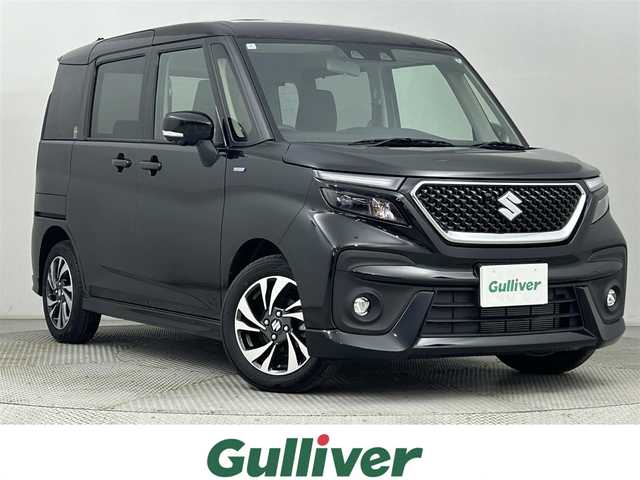 スズキ ソリオ バンディット HV MV 道央・札幌 2024(令6)年 0.5万km スーパーブラックパール ・4WD/・寒冷地仕様/・純正8インチナビ/　CD/DVD/BT/USB/フルセグ/・全方位カメラ/・デュアルカメラサポートブレーキ/・レーダークルーズコントロール/・レーンキープアシスト/・コーナーセンサー/・ヘッドアップディスプレイ/・アイドリングストップ/・横滑り防止装置/・両側パワースライドドア/・サンシェード/・サーキュレーター/・背面テーブル/・プッシュスタート/・スマートキー/・LEDヘッドライト/・フォグライト/・純正フロアマット