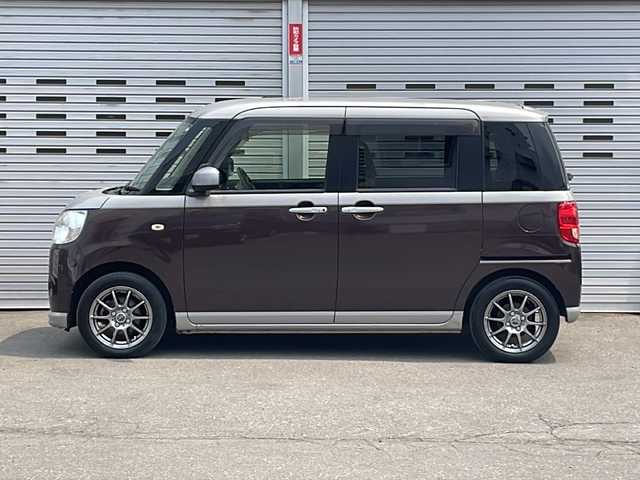 ダイハツ ムーヴ キャンバス X 道央・札幌 2017(平29)年 12.5万km スムースグレーマイカメタリック/プラムブラウンクリスタルマイカ 2トーン (株)IDOMが運営する【じしゃロン札幌店】の自社ローン専用車両になります。こちらは現金またはオートローンご利用価格です。自社ローンご希望の方は別途その旨お申し付けください。//4WD//スマートキー//スペアキー1本//冬タイヤ積載//社外ナビSD//DVD再生//Bluetooth接続//フルセグテレビ//スライドドア両側//ベンチシート//社外アルミホイール//ABS//ヘッドライトLED//横滑り防止装置//レーンアシスト//ダブルエアバック//セキュリティアラーム