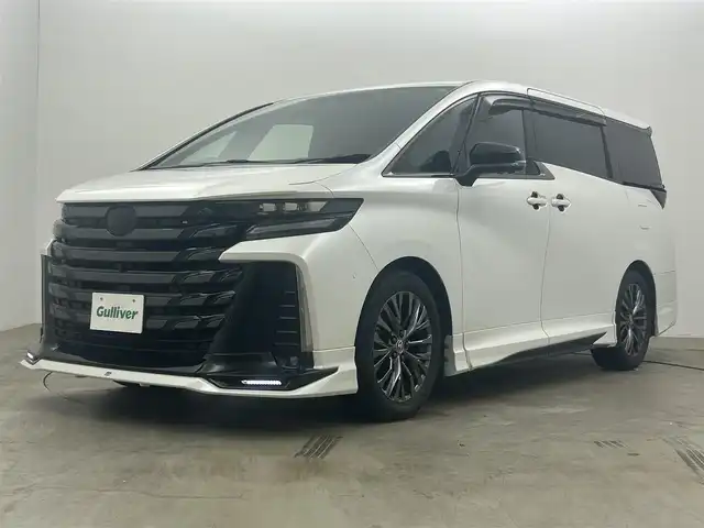トヨタ ヴェルファイア Z プレミア 岡山県 2023(令5)年 1.5万km プラチナホワイトパールマイカ GRエアロ/GRマフラー/デジタルインナーミラー/左右独立ムーンルーフ/純正１４インチディスプレイオーディオ/【ナビ/Bluetooth/フルセグTV/Carplay/HDMI/USB】/茶色レザーシート/トヨタ チームメイト/　・アドバンスト　パーク/　・アドバンスト　ドライブ/トヨタセーフティーセンス/　・プリクラッシュセーフティ/　・レーントレーシングアシスト/　・レーダークルーズコントロール/　・アダプティブハイビームシステム/　・ロードサインアシスト/　・フロントクロストラフィックアラート/パノラミックビューモニター/1列目＆2列目シートヒーター/1列目＆2列目エアシート/ビルトインＥＴＣ２．０/１００Ｖ電源/三眼ＬＥＤヘッドライト/パドルシフト/置くだけ充電/両側電動スライドドア
