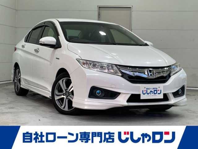 ホンダ グレイス ハイブリッド EX 沖縄県 2014(平26)年 7.3万km ホワイトオーキッドパール (株)IDOMが運営する【じしゃロンコザ店】の自社ローン専用車両になりますこちらは現金またはオートローンご利用時の価格です。自社ローンご希望の方は別途その旨お申付け下さい/・本土仕入/・純正ナビ/・Ｂｌｕｅｔｏｏｔｈ接続/・ＴＶ/・バックカメラ/・ＥＴＣ/・クルーズコントロール/・スマートキー/・プッシュスタート/・シートヒーター/・純正エアロ/・純正アルミホイール/・オートライト