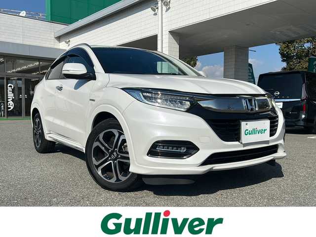 ホンダ ヴェゼル ハイブリッド Z ホンダセンシング 兵庫県 2019(令1)年 6.8万km プラチナホワイトパール 純正ギャザーズナビ【CD/DVD/TV】/ハーフレザーシート/バックカメラ/純正１７インチアルミ/プッシュスタート/ホンダセンシング【衝突軽減ブレーキ】/ルーフレール/パドルシフト/シートヒーター/レーンキープアシスト/オートクルーズコントロール【追従あり】/ACC先行車検知音/先行車発信お知らせ/リアクティブフォースペダル/標識認識機能/ビルトインETC/ブレーキホールド