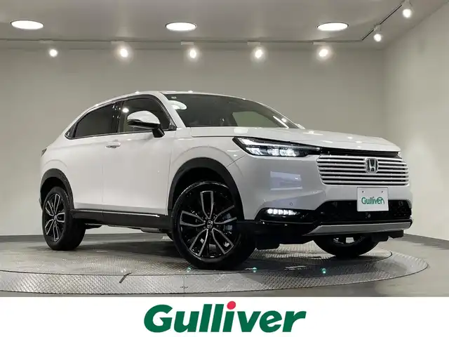 ホンダ ヴェゼル ハイブリッド e:HEV Z 愛知県 2025(令7)年 0.1千km プラチナホワイトパール 登録済未使用車/純正９インチナビ/衝突軽減ブレーキ/レーダークルーズコントロール/ブラインドスポットモニター/クリアランスソナー/車線逸脱警報/パワーバックドア/ヒルディセントコントロール/電動パーキングブレーキ/ブレーキホールド/パドルシフト/ワイヤレス充電/ハーフレザーシート/シートヒーター/ハンドルヒーター/バックカメラ/ビルトインＥＴＣ2.0/USB入力端子/ISOFIX/純正18インチアルミホイール