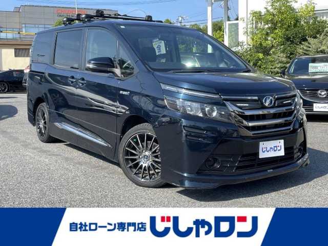 トヨタ ヴォクシー ハイブリッド X 愛知県 2014(平26)年 12.4万km ブラッキッシュアゲハガラスフレーク (株)IDOMが運営する【じしゃロン名古屋鳴海店】の自社ローン専用車両になりますこちらは現金またはオートローンご利用時の価格です。自社ローンご希望の方は別途その旨お申付け下さい/純正9インチナビフルセグTV/バックカメラ/ETC/両側パワースライドドア/社外17インチアルミ/社外アルミ冬タイヤ積込/保証書/スペアキー