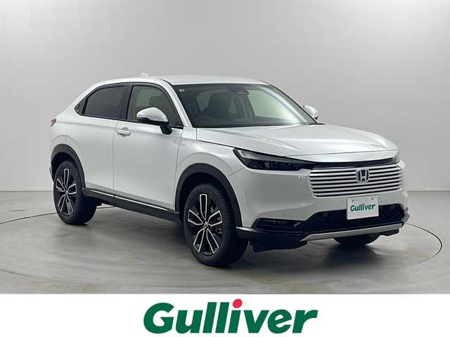 ホンダ ヴェゼル ハイブリッド e:HEV Z 栃木県 2025(令7)年 0.1千km プラチナホワイトパール 登録済未使用車/Honda CONNECTディスプレイオーディオ（ナビ付）/（フルセグ／Bluetooth／AppleCarPley／AndroidAuto）/バックカメラ/ホンダセンシング/・衝突軽減ブレーキ/・レーンキープアシスト/・レーダークルーズコントロール/・前後コーナーセンサー/・オートハイビーム/・ブラインドスポットモニター/・標識認識機能/・先行車発進機能/電動リアゲート/ビルトインETC2.0/前席シートヒーター/ステアリングヒーター/パドルシフト/オートLEDヘッドライト/フォグランプ/置くだけ充電/電動ホールド/ステアリングスイッチ/スマートスペアキー
