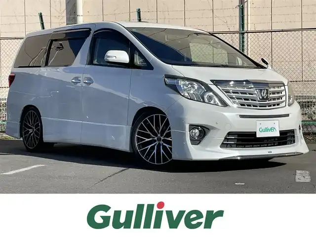 トヨタ アルファード 240S タイプゴールドⅡ 東京都 2014(平26)年 7.7万km ホワイトパールクリスタルシャイン 純正ナビ/純正フリップダウンモニター/バックカメラ/フルセグTV/フロント/リアモデリスタスポイラー/ETC/ツインムーンルーフ/両側電動スライドドア/パワーバックドア/ハーフレザーシート/前方ドライブレコーダー/横滑り防止装置/純正フロアマット/サイドバイザー/クルーズコントロール/スマートキー/オットマン/社外20インチAW