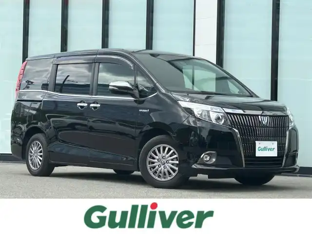 トヨタ エスクァイア ハイブリッド Gi ブラックテーラード 大阪府 2016(平28)年 6.9万km ブラック 社外８インチナビ/   フルセグTV/CD/DVD/Bluetooth/バックモニター/衝突軽減ブレーキ/横滑り防止装置/レーントレーシングアシスト/前席シートヒーター/両側パワースライドドア/クルーズコントロール/アイドリングストップ/オートマチックハイビーム/ドライブレコーダー/純正フロアマット/プッシュスタート/スマートキー/ＥＴＣ/ＬＥＤライト