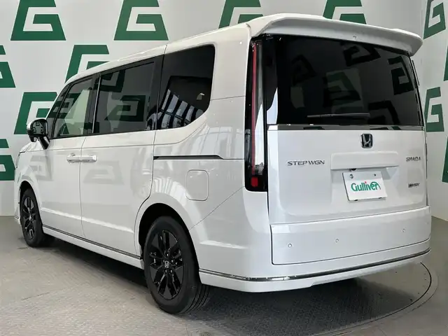 ホンダ ステップワゴン スパーダ eHEV 鹿児島県 2025(令7)年 0.1万km未満 プラチナホワイトパール 登録済未使用車/ホンダセンシング/・衝突軽減ブレーキ/・誤発進抑制機能（前後）/・歩行者事故低減ステアリング/・路外逸脱抑制機能/・渋滞追従機能付アダプティブクルーズコントロール/・車線維持支援システム/・渋滞運転支援機能/・先行車発進お知らせ機能/・標識認識機能/・オートハイビーム/・パーキングセンサーシステム/ブラインドスポットインフォメーション/アダプティブドライビングビーム/純正11インチメモリナビ【LXM-247VFLi】/（CD/DVD/フルセグ/Bluetooth/SD/USB）/バックカメラ/ハーフレザーシート/前席シートヒーター/2列目オットマン/全列USBチャージャー/革巻きステアリング/ステアリングリモコン/パドルシフト/電動パーキングブレーキ/ブレーキホールド/純正LEDヘッドライト/フロントフォグランプ/オートライト/ヘッドライトレベライザー/純正16インチアルミ/保証書&取扱説明書