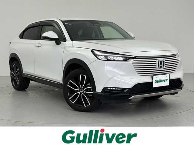 ホンダ ヴェゼル ハイブリッド e:HEV Z 愛知県 2023(令5)年 3万km プラチナホワイトパール エンジンスタートボタン/スマートキー（スペアキー１本）/アイドリングストップ/パワーステアリング/パワーウインドウ/寒冷地仕様/オートエアコン/クルーズコントロール/ETC2.0/USB入力端子/バックカメラ/純正ナビ（BT.フルセグ）/Honda CONNECTディスプレー＋ETC2.0車載器＋ワイヤレス充電器/D席N席シートヒーター/親水/ヒーテッドドアミラー＋熱線入りフロントウインドウ＋運転席助手席シートヒーター/電動リアゲート/ハンズフリーアクセスパワーテールゲート(予約クローズ機能付)/LEDライト/LEDシーケンシャルターンシグナルランプ/コンビシート/純正18インチアルミホイール/純正フロアマット/ABS/横滑り防止装置/コーナーセンサー前後/レーンキープアシスト/オートライト/オートマチックハイビーム/Honda SENSING/ダウンヒルアシストコントロール/W+サイドエアバック/カーテンエアバック