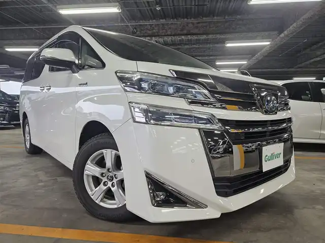 トヨタ ヴェルファイア ハイブリット X 福岡県 2018(平30)年 7.8万km ホワイトパールクリスタルシャイン 4WD/純正10型ナビ/フルセグTV/両側パワースライドドア/バックカメラ/ビルトインETC2.0/デジタルインナーミラー/ドライブレコーダー/レーダークルーズコントロール/クリアランスソナー/セーフティセンス/・衝突被害軽減ブレーキ/・車線逸脱防止支援システム/・交通標識認識システム/・オートマチックハイビーム/2眼LEDヘッドランプ/デュアルオートエアコン/革巻きステアリング/ベージュファブリックシート/2列目チップアップシート/純正16インチAWスタッドレス/スマートキー/プッシュエンジンスタート/禁煙車
