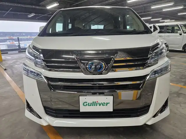 トヨタ ヴェルファイア ハイブリット X 福岡県 2018(平30)年 7.8万km ホワイトパールクリスタルシャイン 4WD/純正10型ナビ/フルセグTV/両側パワースライドドア/バックカメラ/ビルトインETC2.0/デジタルインナーミラー/ドライブレコーダー/レーダークルーズコントロール/クリアランスソナー/セーフティセンス/・衝突被害軽減ブレーキ/・車線逸脱防止支援システム/・交通標識認識システム/・オートマチックハイビーム/2眼LEDヘッドランプ/デュアルオートエアコン/革巻きステアリング/ベージュファブリックシート/2列目チップアップシート/純正16インチAWスタッドレス/スマートキー/プッシュエンジンスタート/禁煙車