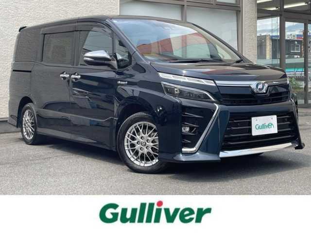 トヨタ ヴォクシー ハイブリッド ZS 煌Ⅱ 大阪府 2019(令1)年 4.5万km ブラッキッシュアゲハガラスフレーク T-Connect１０インチナビ（NSZN-Z68T）/純正12.1インチフリップダウンモニター（V12T-R68C)/クルーズコントロール/バックモニター/両側パワースライドドア/前後コーナーセンサー/衝突軽減システム/レーンキープアシスト/前席シートヒーター/後席サンシェード/純正ドライブレコーダー/純正ＥＴＣ/純正16インチAW/保証書/取り扱い説明書/スペアキーX1