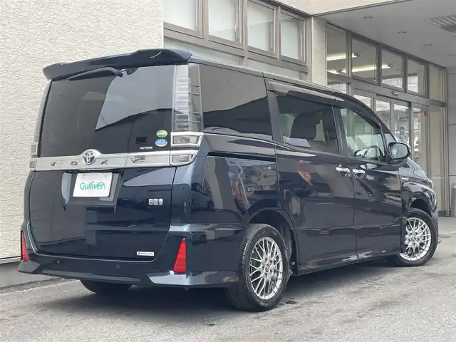 トヨタ ヴォクシー ハイブリッド ZS 煌Ⅱ 大阪府 2019(令1)年 4.5万km ブラッキッシュアゲハガラスフレーク T-Connect１０インチナビ（NSZN-Z68T）/純正12.1インチフリップダウンモニター（V12T-R68C)/クルーズコントロール/バックモニター/両側パワースライドドア/前後コーナーセンサー/衝突軽減システム/レーンキープアシスト/前席シートヒーター/後席サンシェード/純正ドライブレコーダー/純正ＥＴＣ/純正16インチAW/保証書/取り扱い説明書/スペアキーX1
