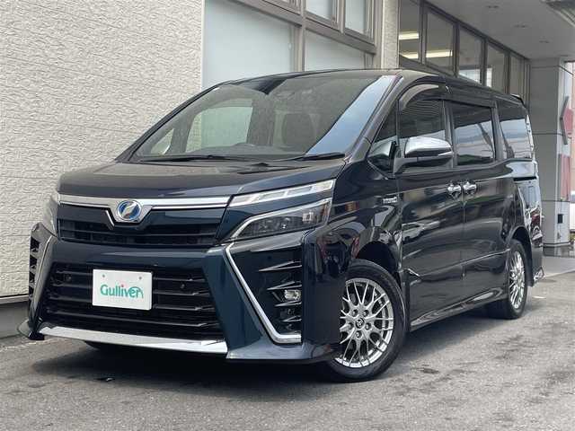 トヨタ ヴォクシー ハイブリッド ZS 煌Ⅱ 大阪府 2019(令1)年 4.5万km ブラッキッシュアゲハガラスフレーク T-Connect１０インチナビ（NSZN-Z68T）/純正12.1インチフリップダウンモニター（V12T-R68C)/クルーズコントロール/バックモニター/両側パワースライドドア/前後コーナーセンサー/衝突軽減システム/レーンキープアシスト/前席シートヒーター/後席サンシェード/純正ドライブレコーダー/純正ＥＴＣ/純正16インチAW/保証書/取り扱い説明書/スペアキーX1