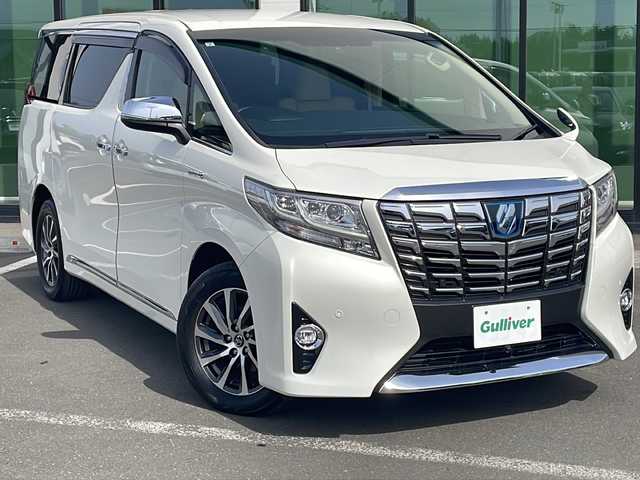 トヨタ アルファードハイブリット G Fパッケージ 道東・釧路十勝 2015(平27)年 7.9万km ラグジュアリーホワイトパールクリスタルシャインガラスフレーク ・４WD/・純正9インチナビ/（CD・DVD・フルセグ・BT・ラジオ）/・バックカメラ/・レーダークルーズコントロール/・両側電動スライドドア/・パワーバックドア/・プリクラッシュセーフティ/・LEDヘッドライト/・革巻きステアリング/・ステアリングヒーター/・クリアランスソナー/・オートマチックハイビーム/・スマートキー/・プッシュスタート/・レザーシート/・前席パワーシート/・前席シートヒーター/・助手席電動オットマン/・セカンドシート電動リクライニング/・セカンドシート電動オットマン/・AC100V（1500Wコンセント）/・ビルトンインETC/・保証書