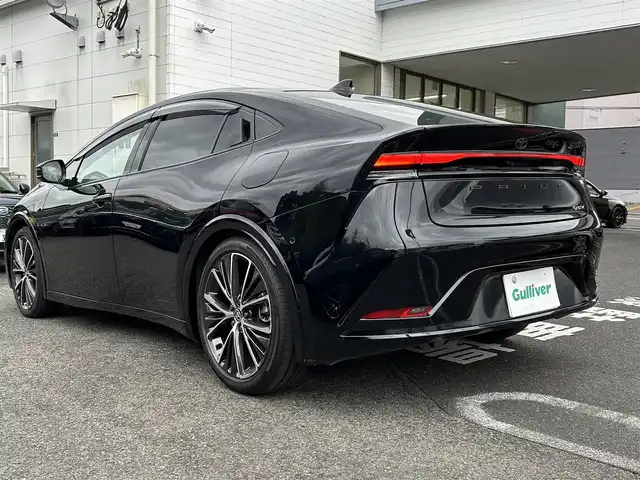 トヨタ プリウス Z 長崎県 2024(令6)年 7万km アティチュードブラックマイカ プッシュスタート/純正ナビ付ディスプレイオーディオ（AM/FM/BT/TV)/クルーズコントロール/オートライト/オートハイビーム/ハンドルヒーター/シートヒーター（D/N)/エアシート（D/N)/パワーバックドア/ETC2.0/電子サイドブレーキ/ブレーキホールド/バックカメラ/全方位カメラ/トヨタセーフティセンス/横滑り防止装置/レーンキープアシスト/充電Cタイプ/AC100V/デジタルインナーミラー
